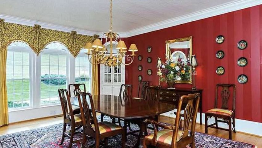 Dining room with red striped walls and faux tin ceiling painted white