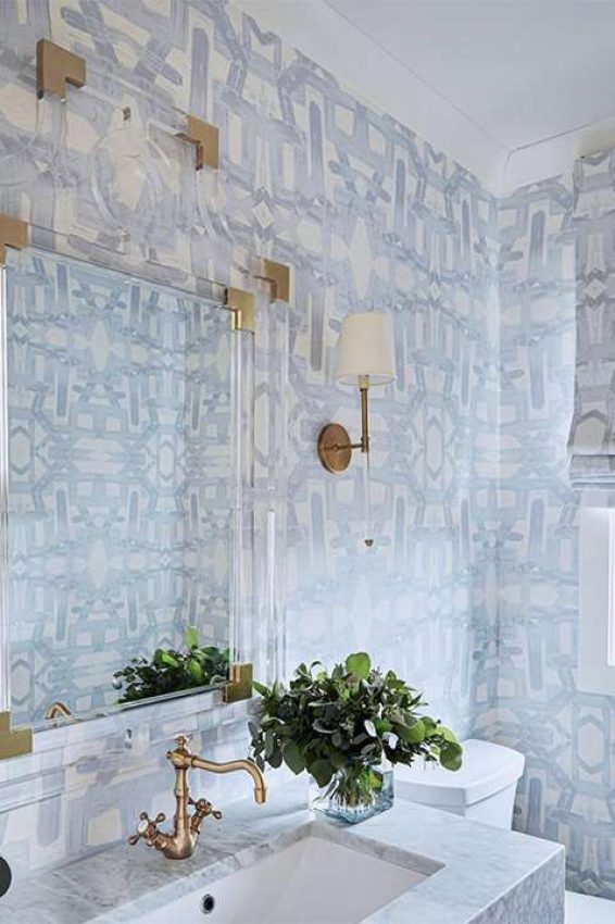 bathroom with a blue and white abstract wallpaper and matching roman shade