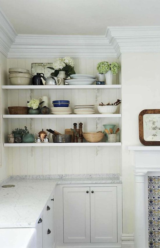 Cottage style kitchen with bead board backsplash and floating shelves