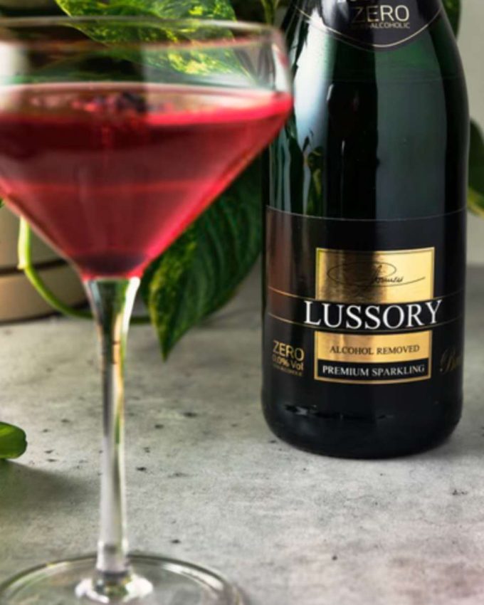 a coupe glass filled with hibiscus spritzer