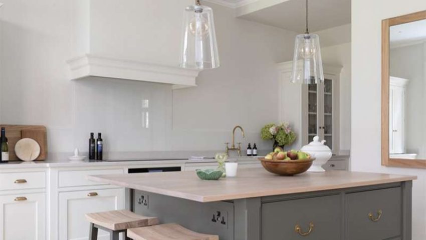 Marble slab backsplash with green-grey island with wood top