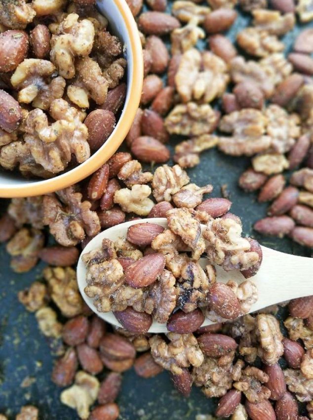 mixed nuts in a bowl, on a board, and on a spoon, roasted and spiced - comfort food
