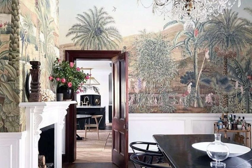 dining room with colorful mural wallpaper depicting life in India above white wainscoting