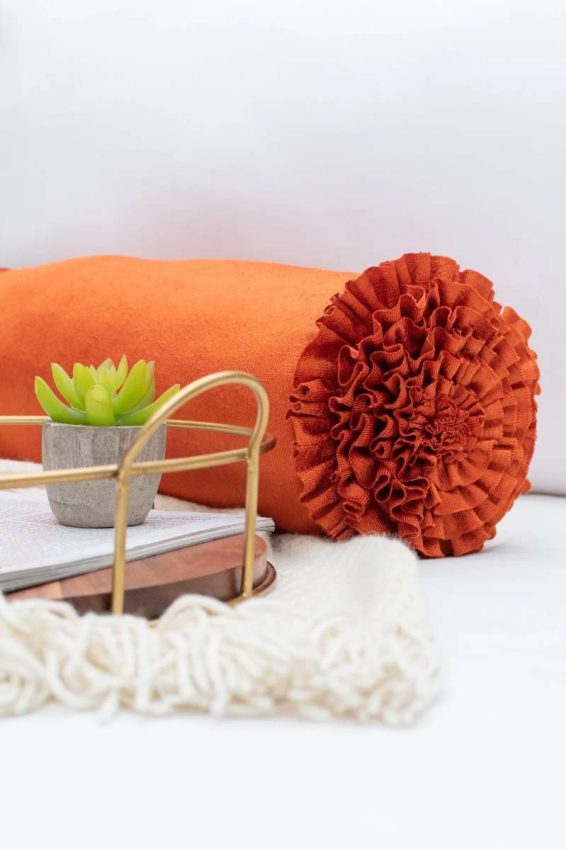 orange bolster with ruffled edge