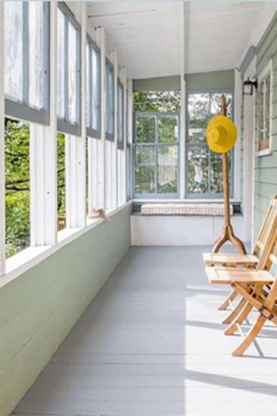 Enclosed porch addition with green clapboard