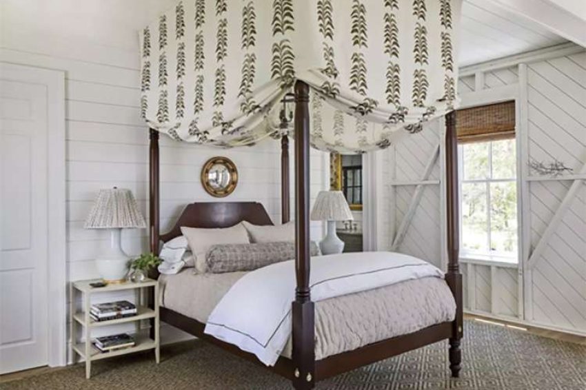 Bedroom with planking and bracing on the walls featuring a canopy bed