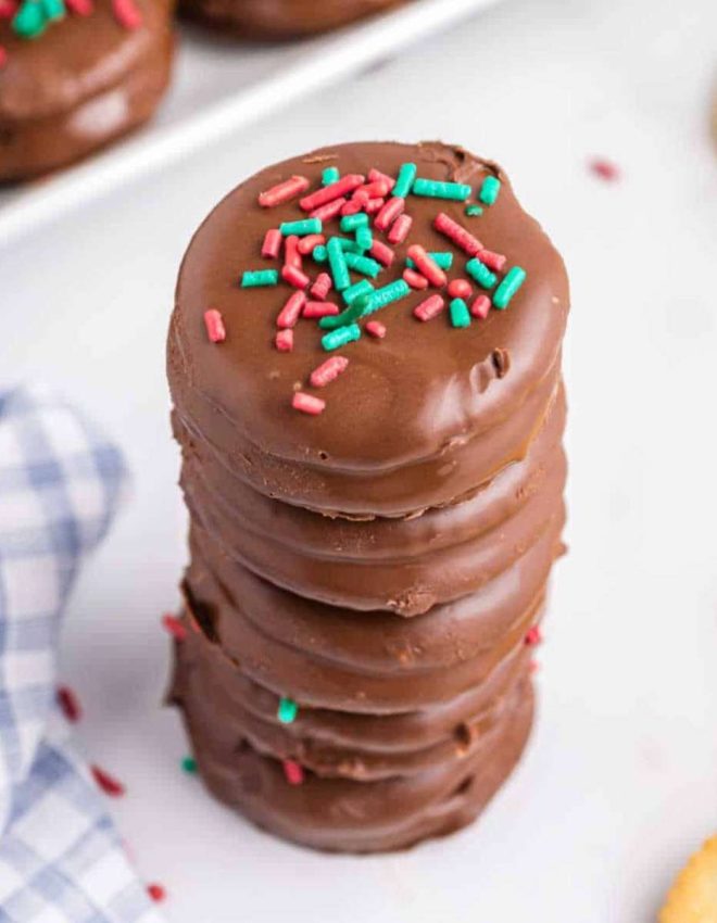a stack of ritz cracker cookies with sprinkles on top