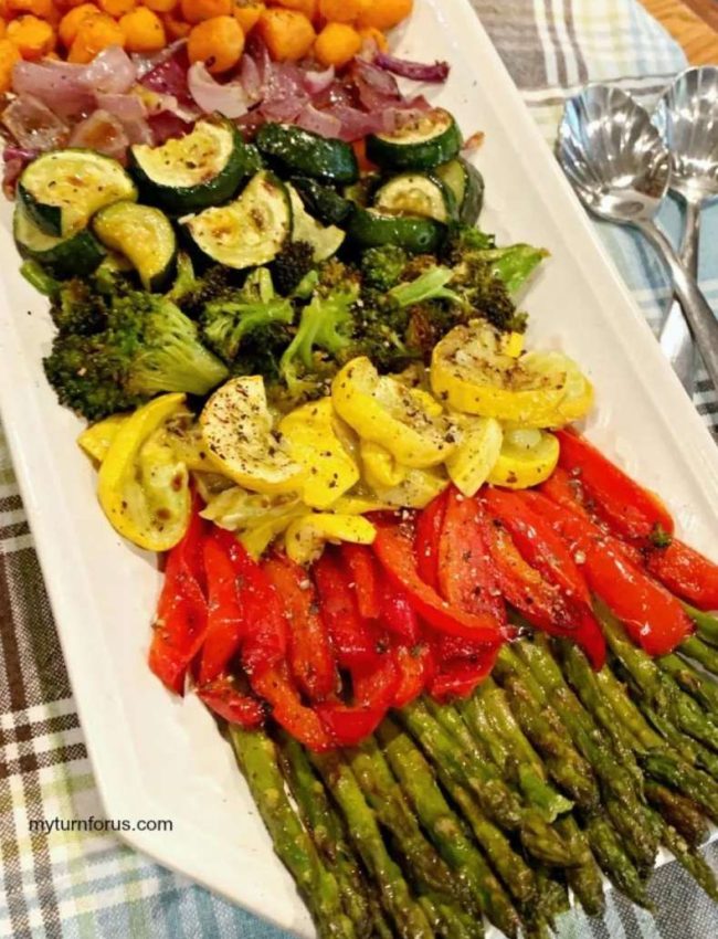 a platter of roasted veggies - asparagus, red peppers, yellow squash, broccoli, zucchini, and carrots