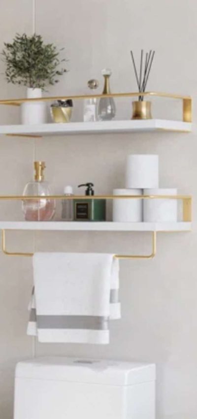 2 shelves above the toilet with pretty toiletries