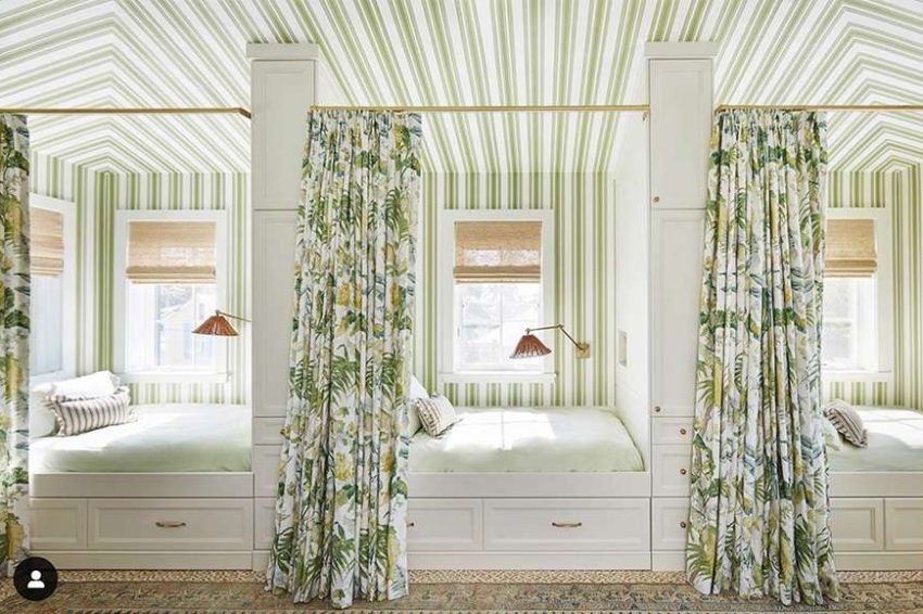 Bedroom with 3 built-in full-size beds, floral curtains, and striped wallpaper