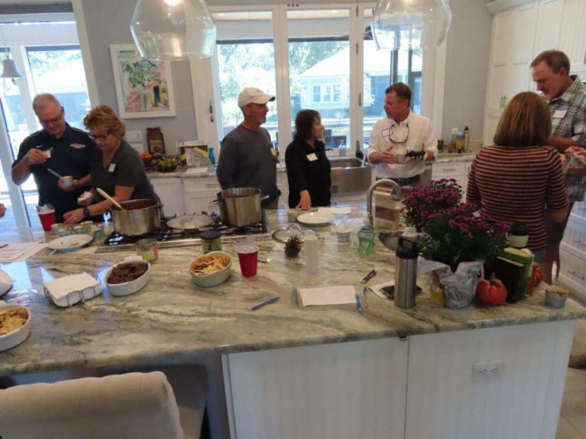 photo showing neighbors tasting chili
