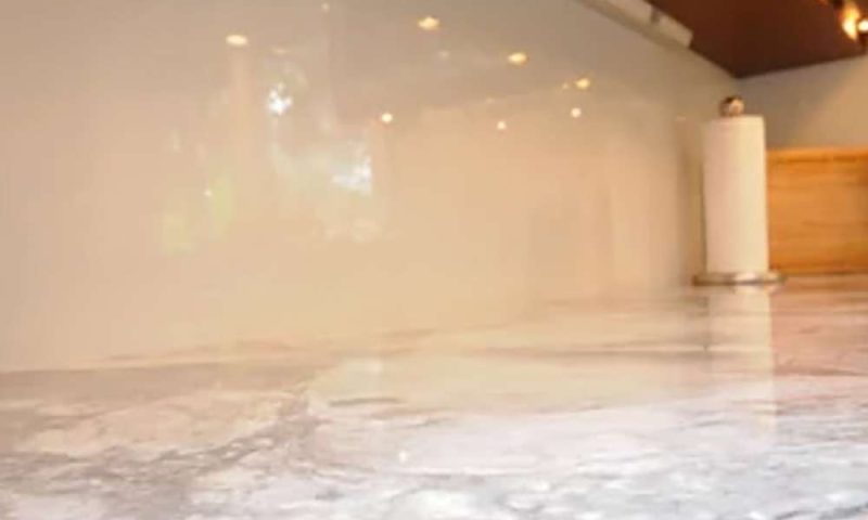 under cabinet electrical strip with shiny clean backsplash and marble counters