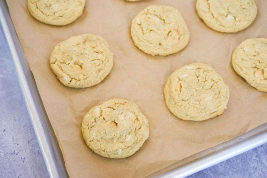 rows of white chocolate macadamia nut cookies on a sheet pan