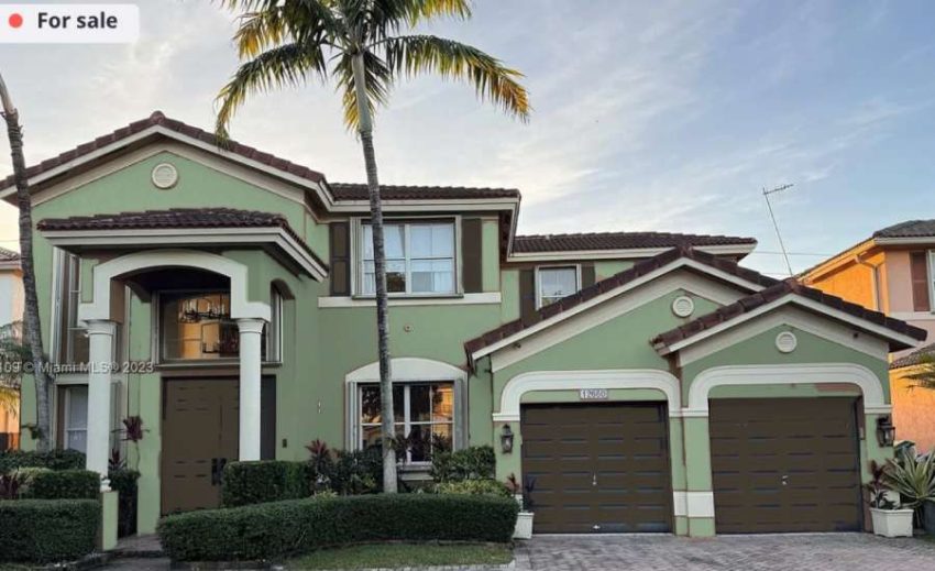 home exterior underwent a color transformation with green paint and bronze shutters, garage doors, and front.