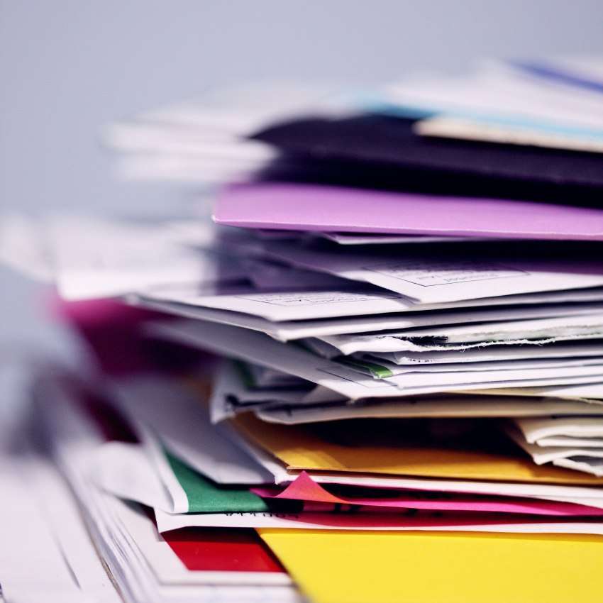 a stack of files and paper that desperately need to be organized and put away