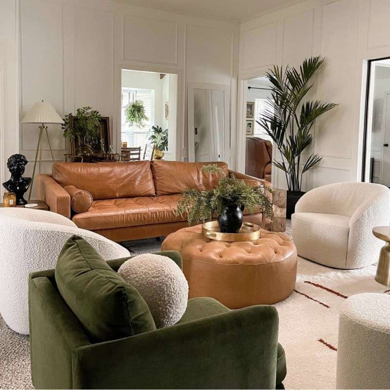 contemporary living room with cognac leather sofa and deep green velvet chair